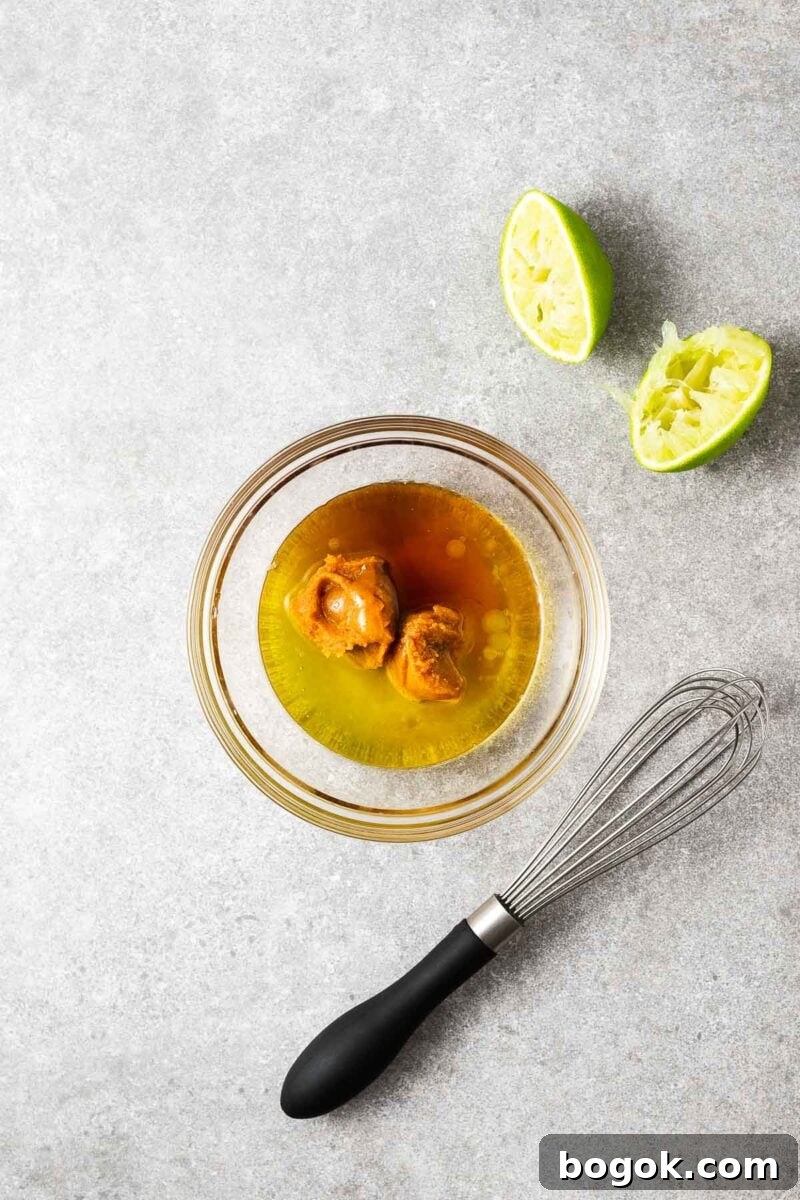 Miso Lime Vinaigrette Recipe — Tangy Asian Dressing 4 The ingredients for miso lime vinaigrette in a small bowl before being whisked to combine.
