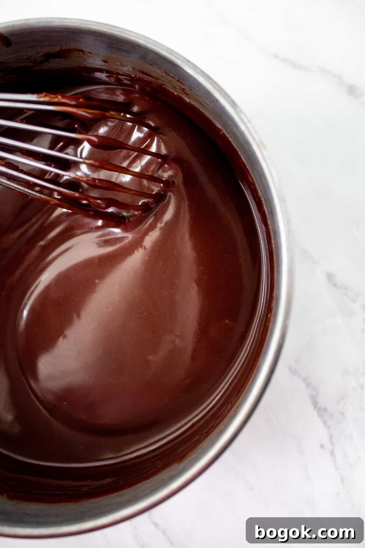 chocolate fudge topping being whisked