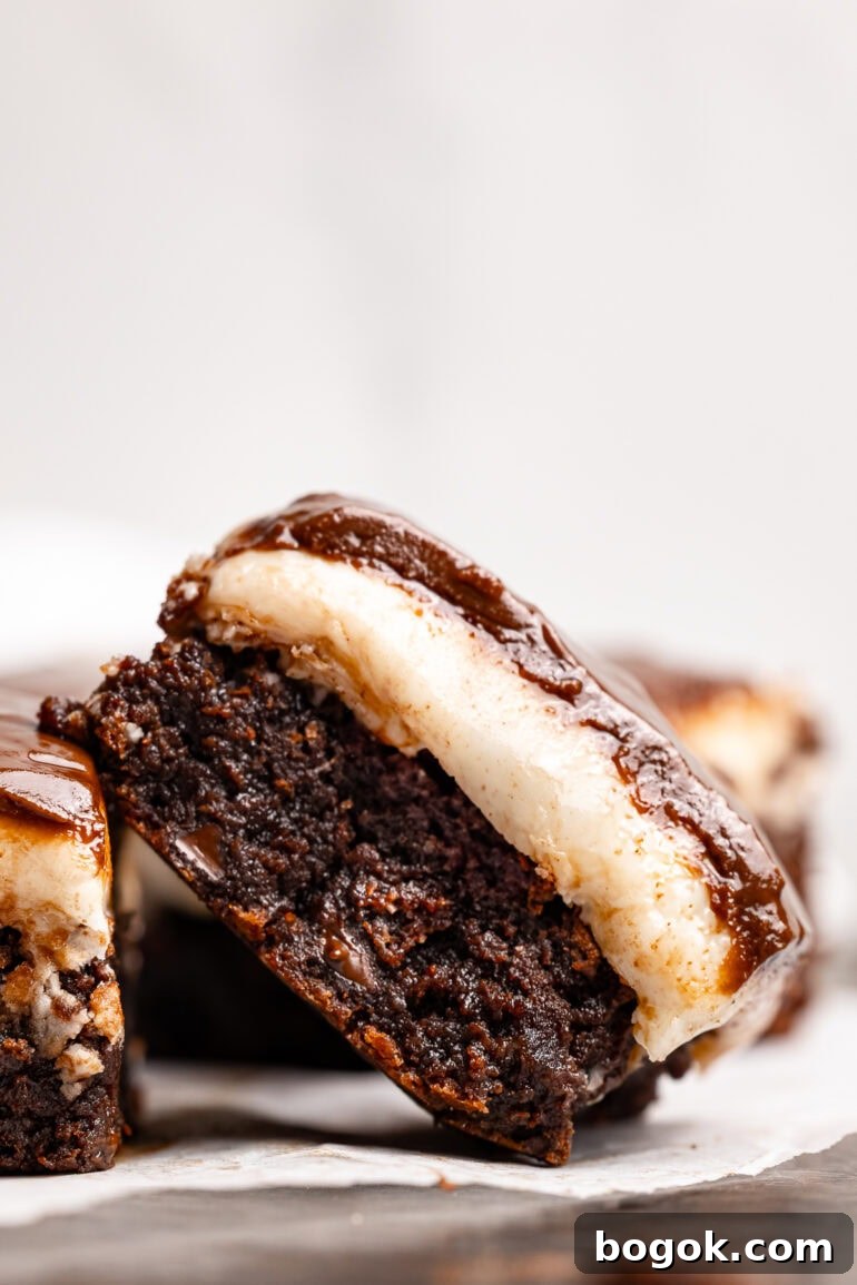 a single peppermint patty brownie tilted on it's side showing the creamy peppermint layer and thin, glossy chocolate layer on top