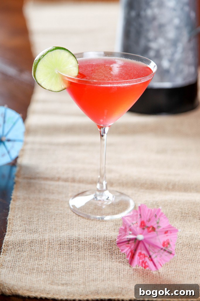 Raspberry Daiquiri Recipe: Refreshing Cocktail Guide 2 a Raspberry Daiquiri drink garnished with a slice of lime.
