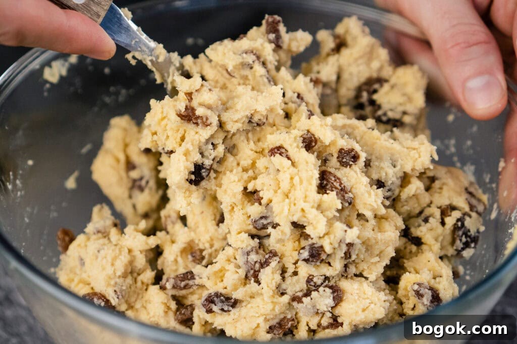 Raw sticky mixture for rock cakes being mixed together with a fork