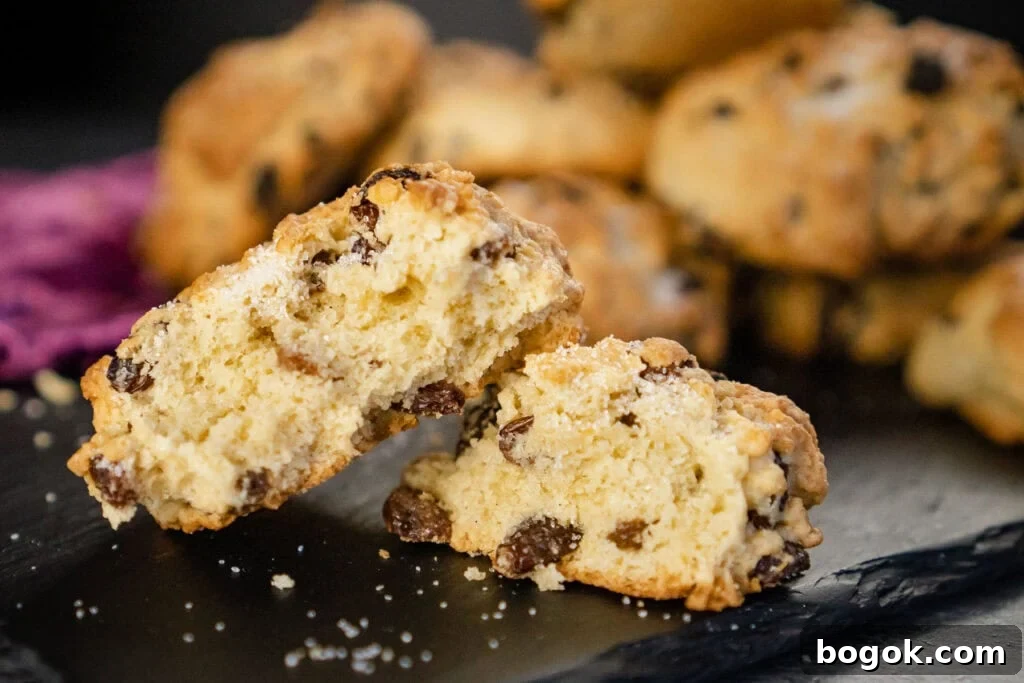 Close up picture of a rock cake broken in half served on a slate plate