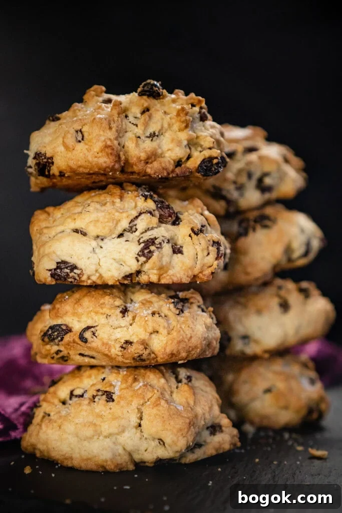 Rock cakes stacked in rows of four on a black slate plate