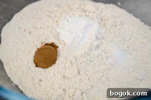Plain flour, mixed spice, baking soda and salt in a glass bowl