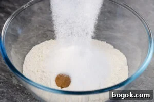sugar added to Plain flour, mixed spice, baking soda and salt in a glass bowl