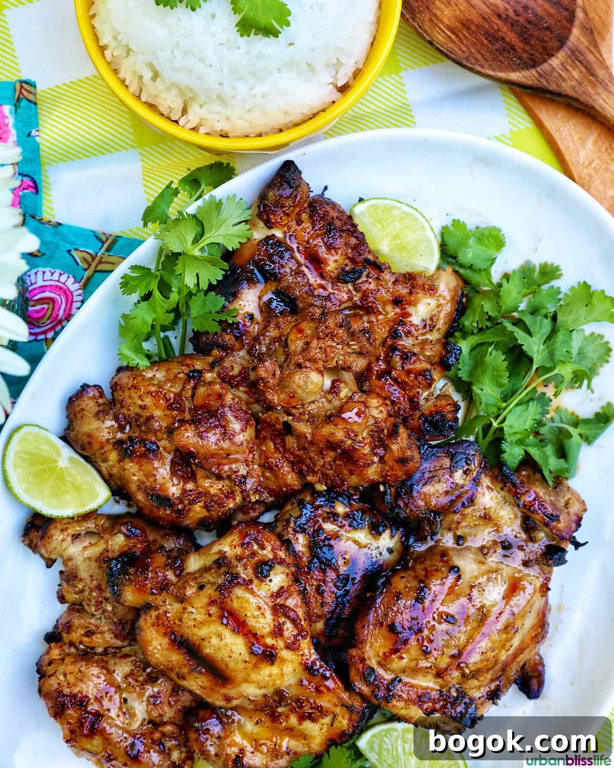 Philippine Chicken Inasal Recipe: Grilled Marinade & Tips 4 Filipino grilled chicken inasal on a platter near a bowl of rice.