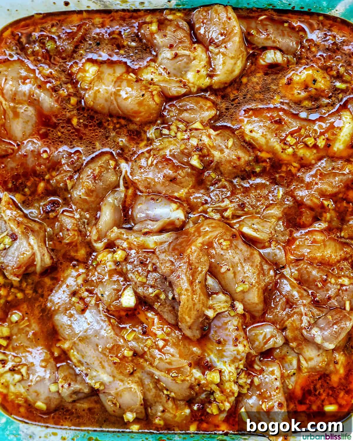 Philippine Chicken Inasal Recipe: Grilled Marinade & Tips 7 chicken marinating in inasal marinade.