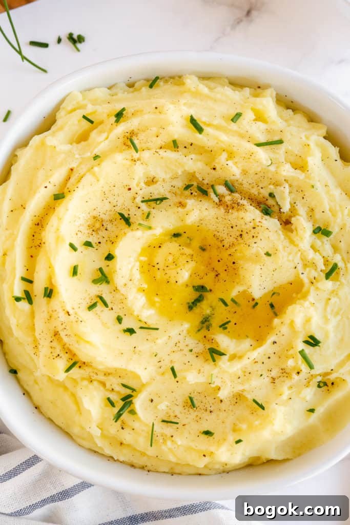 Mashed potatoes topped with butter and chives.