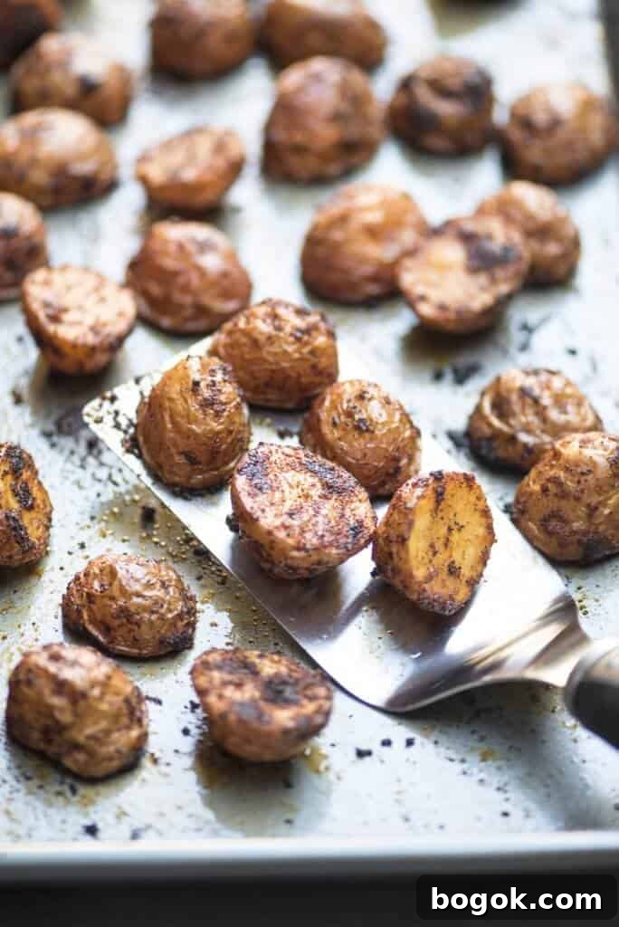 Spiced roasted BBQ potatoes on a sheet pan.