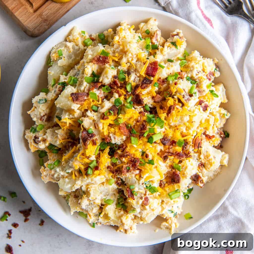 Baked potato salad with bacon, cheese, and green onions.