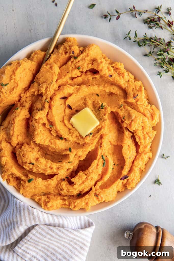 Mashed sweet potatoes topped with butter and thyme.