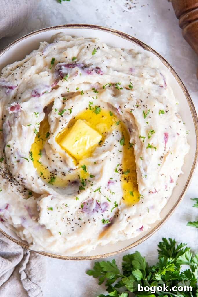 Red-skinned mashed potatoes topped with butter.