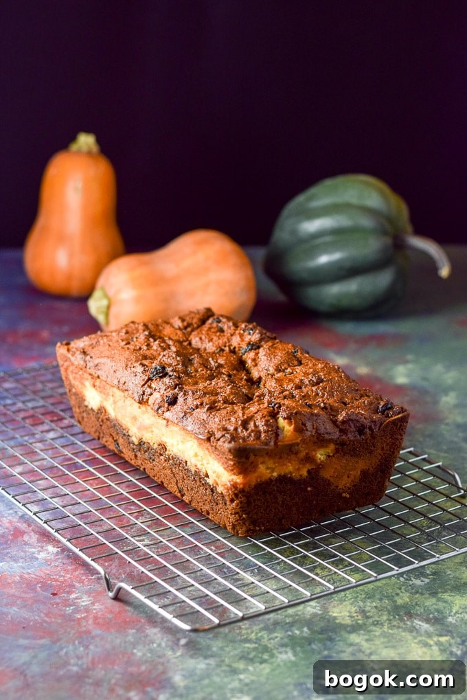 layered Pumpkin bread cooling on the wire rack. There are also whole squashes in the background