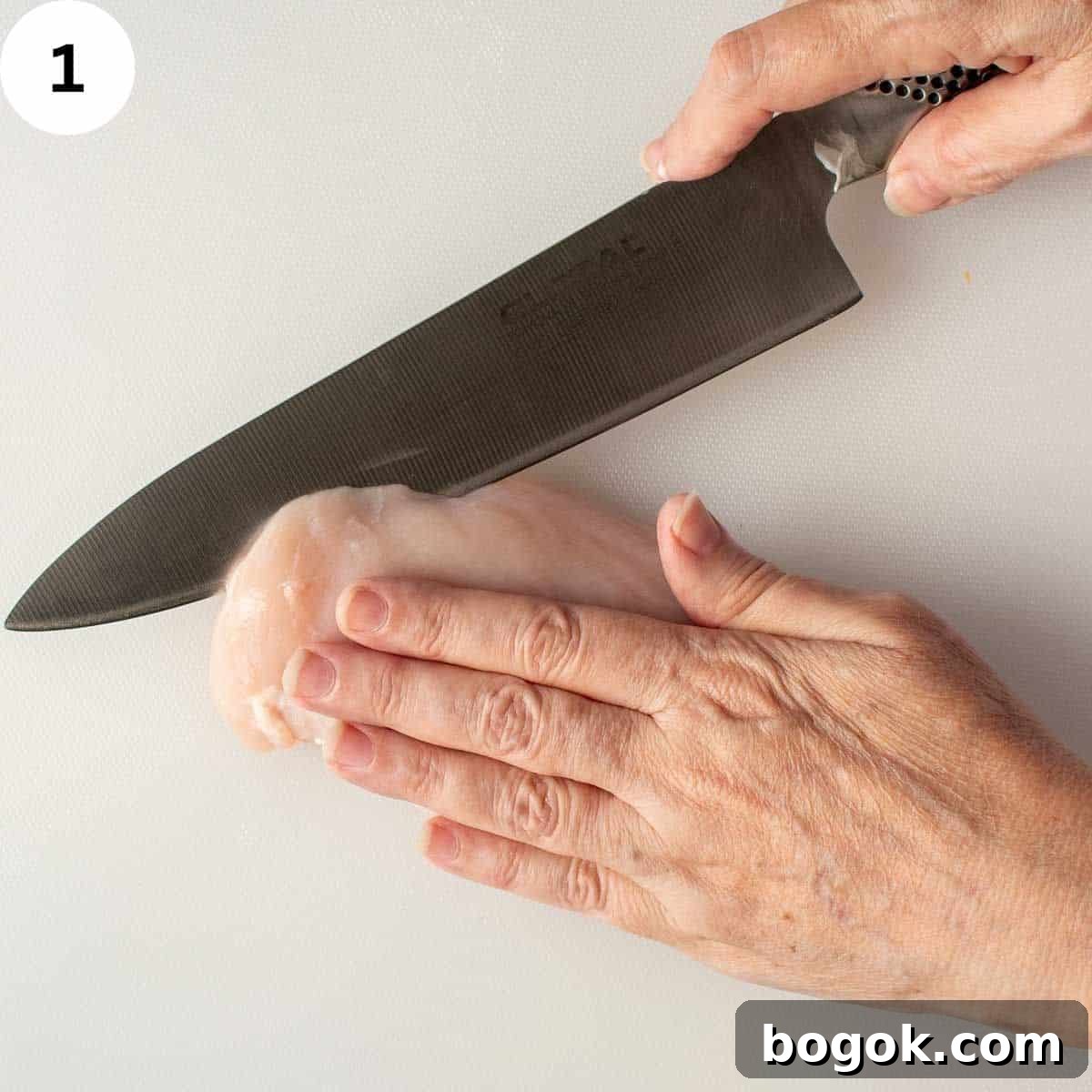 Slicing chicken breast in half lengthwise.