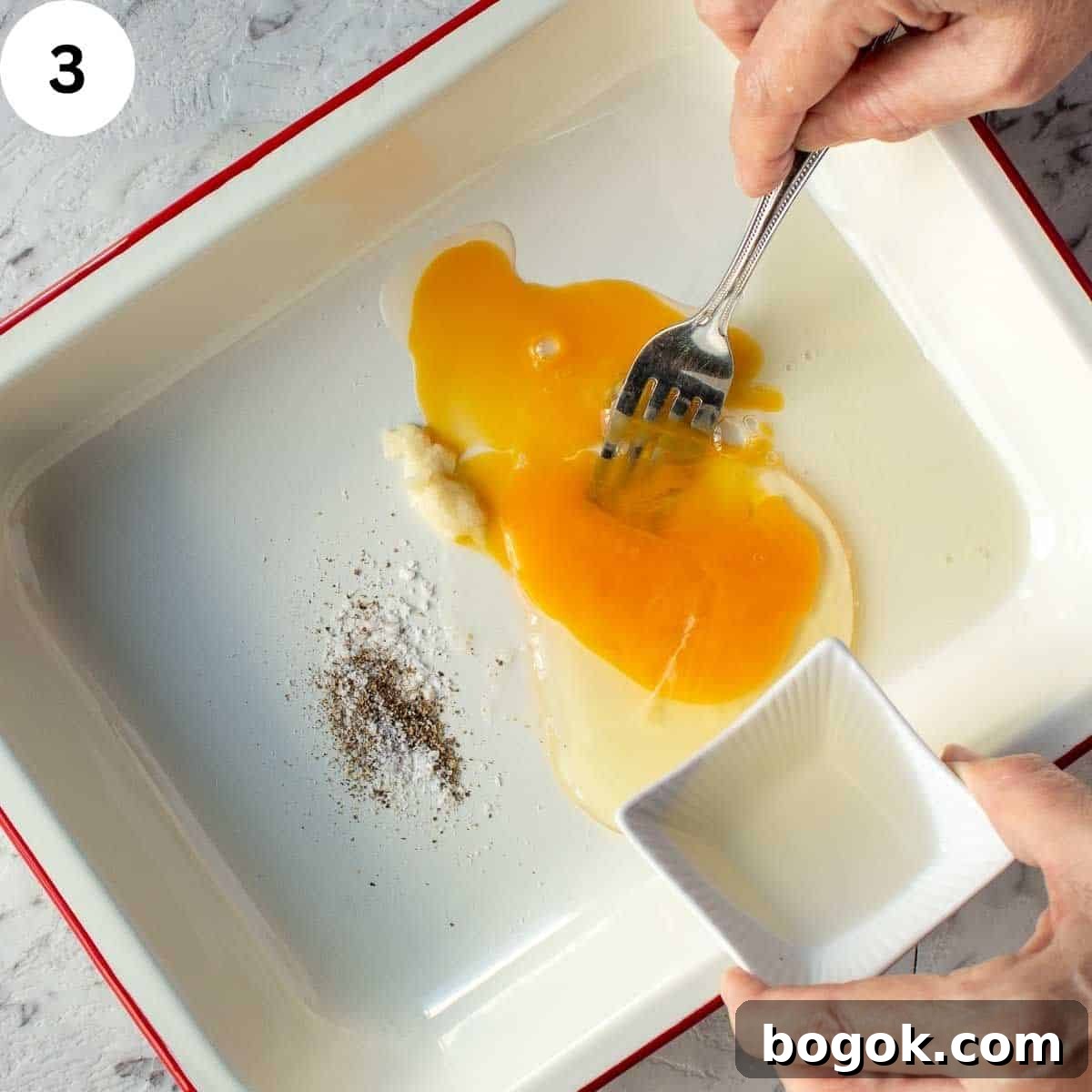 Whisking an egg with other ingredients.