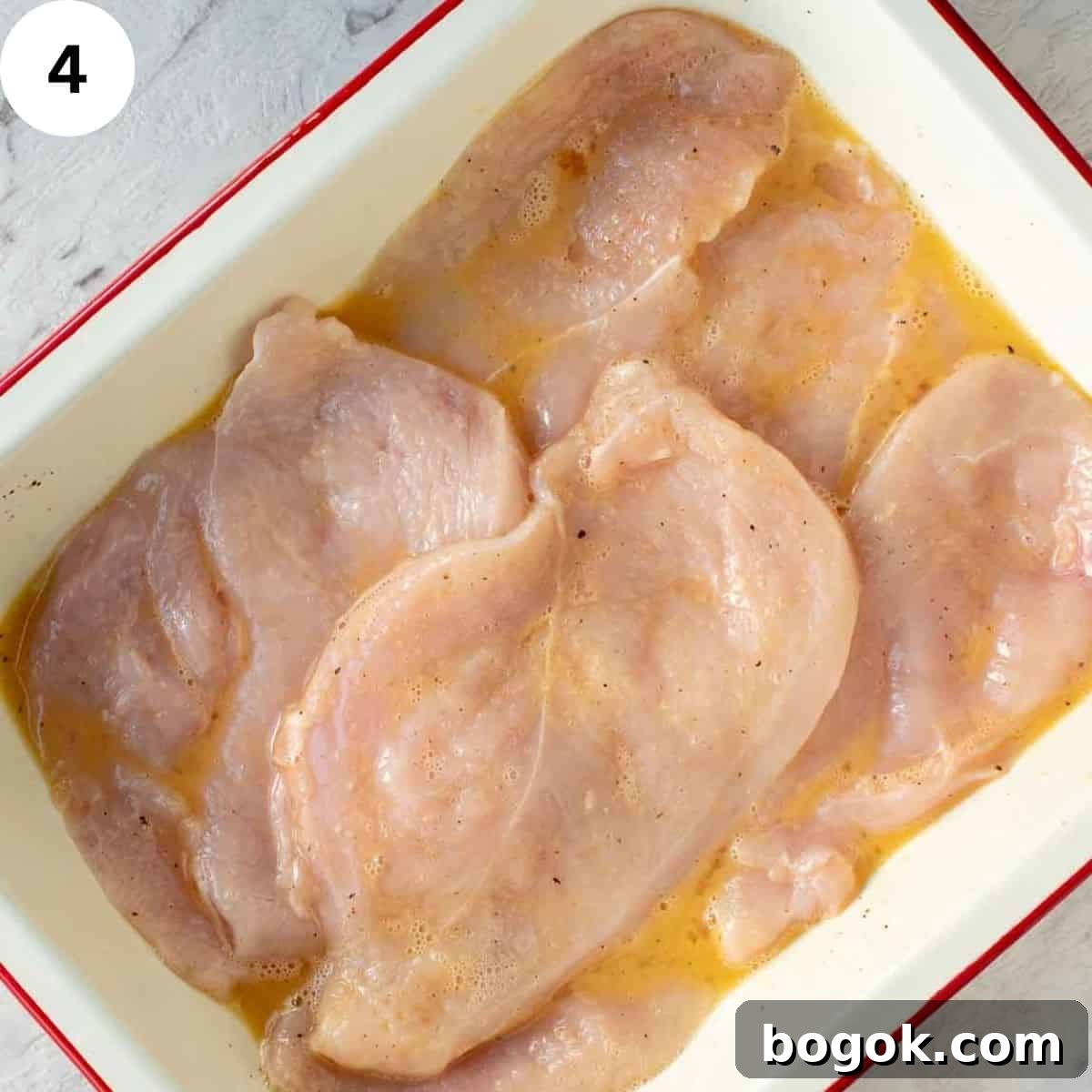 Chicken breasts in eggy marinade.