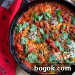 Smoky Rose Harissa: Spicy Condiment with Floral Notes 9 face down view of shakshuka in pan ready to eat