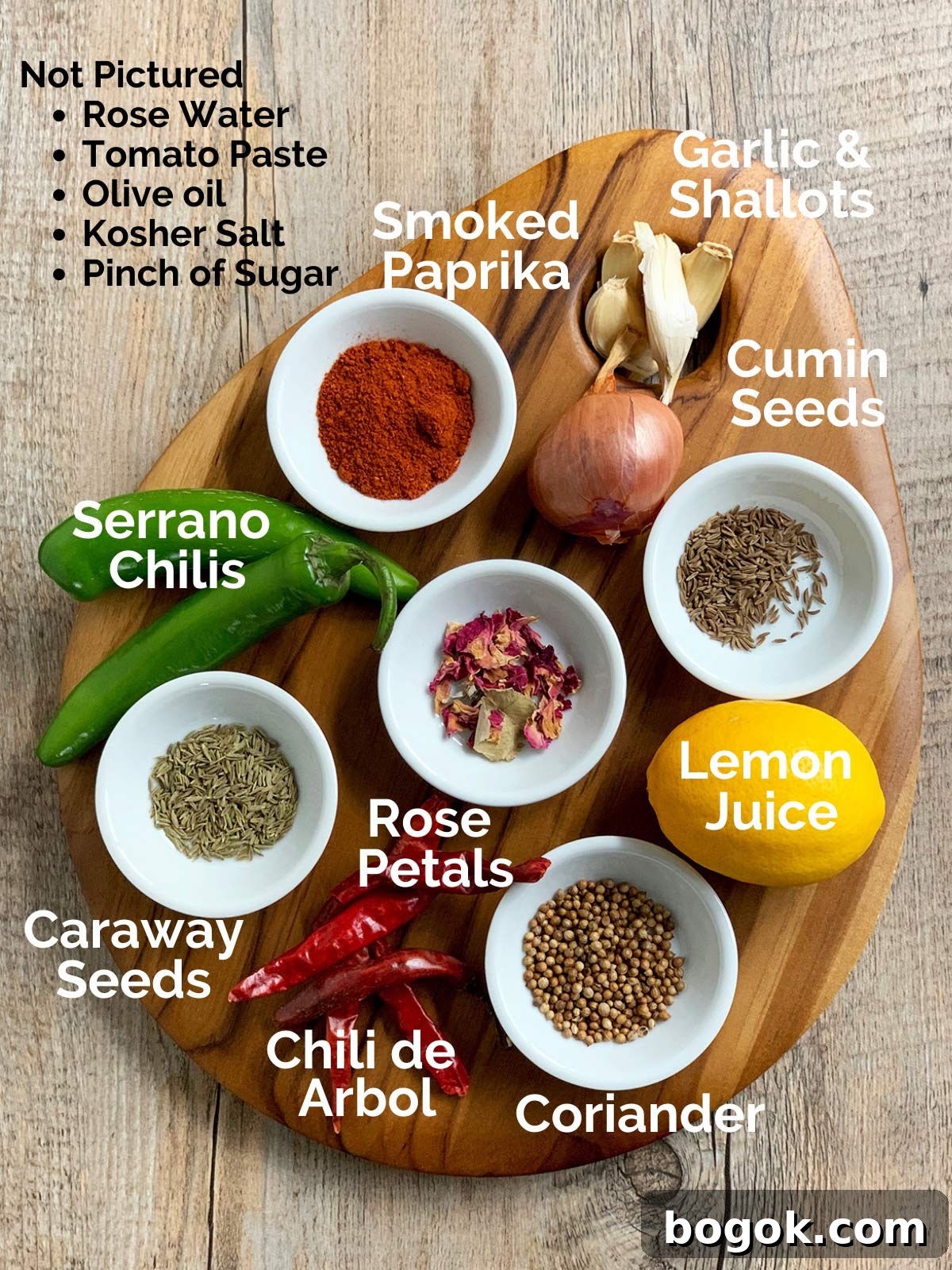 Smoky Rose Harissa: Spicy Condiment with Floral Notes 3 Ingredient shot for rose harissa with ingredients on a wooden cutting board.