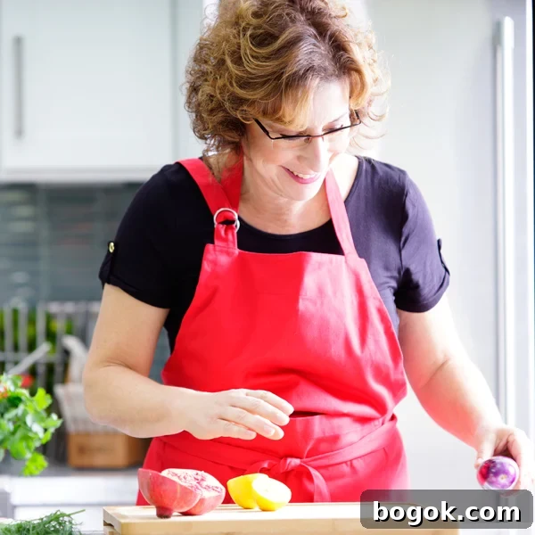 Smoky Rose Harissa: Spicy Condiment with Floral Notes 15 Beth Lee in red apron looking at vegetables on cutting board