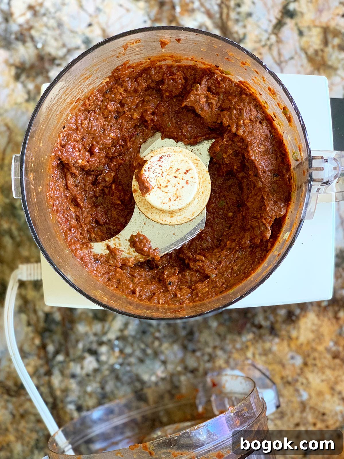 Smoky Rose Harissa: Spicy Condiment with Floral Notes 7 Rose harissa ingredients in mini food processor.