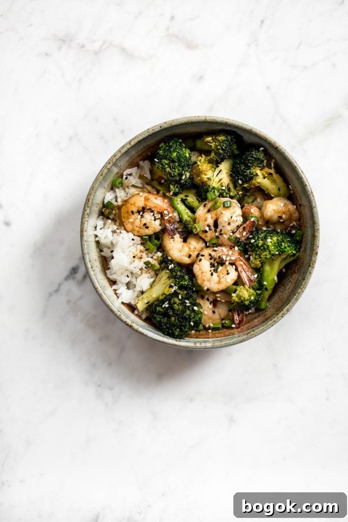 shrimp and broccoli bowl over rice on a marble surface