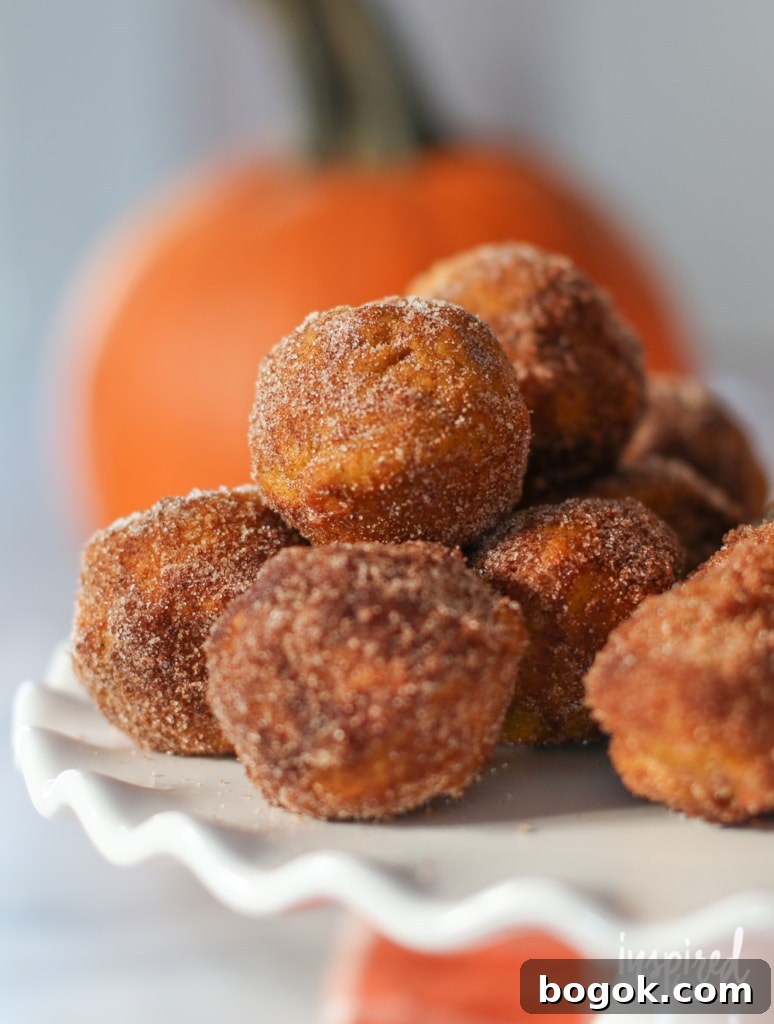 close up of baked pumpkin donuts open a cake stand.