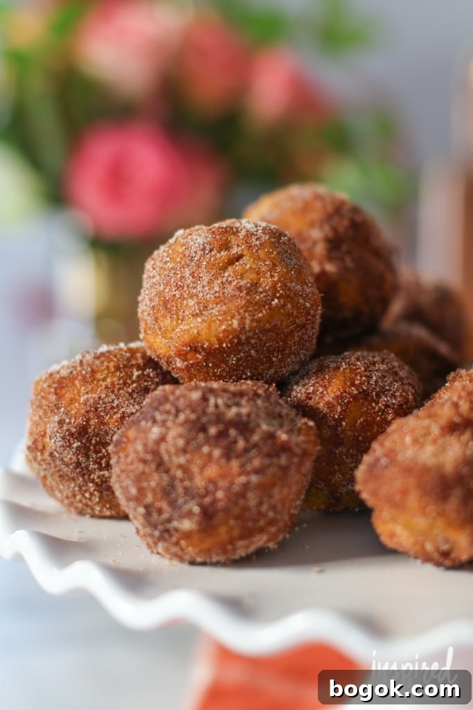Baked Pumpkin Donuts balls on a cake stand.