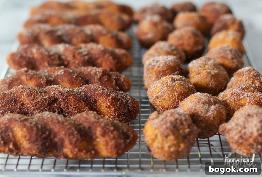 baked pumpkin donuts on a cooling rack.