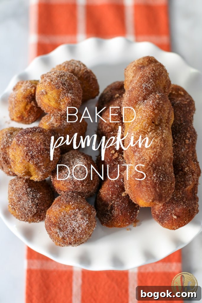 baked pumpkin donuts on a cake stand with title text.