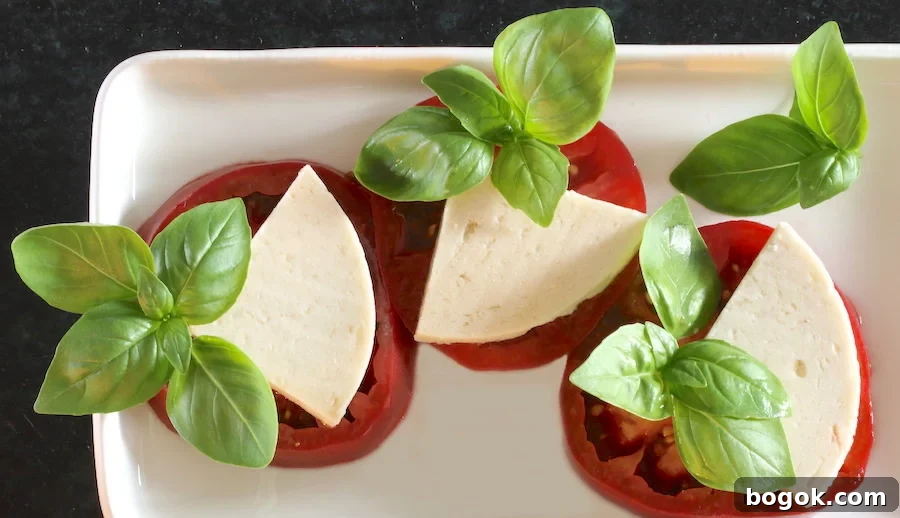 Three tomato slabs with cashew cheese and basil