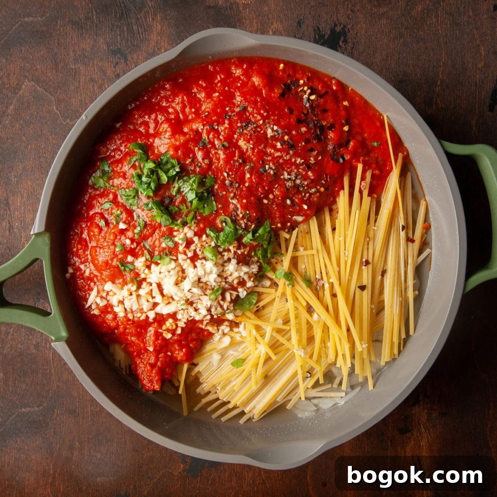 Vegan One-Pot Pasta with Classic Marinara Sauce 5 adding all the ingredients for on-pot vegan pasta into the saucepan