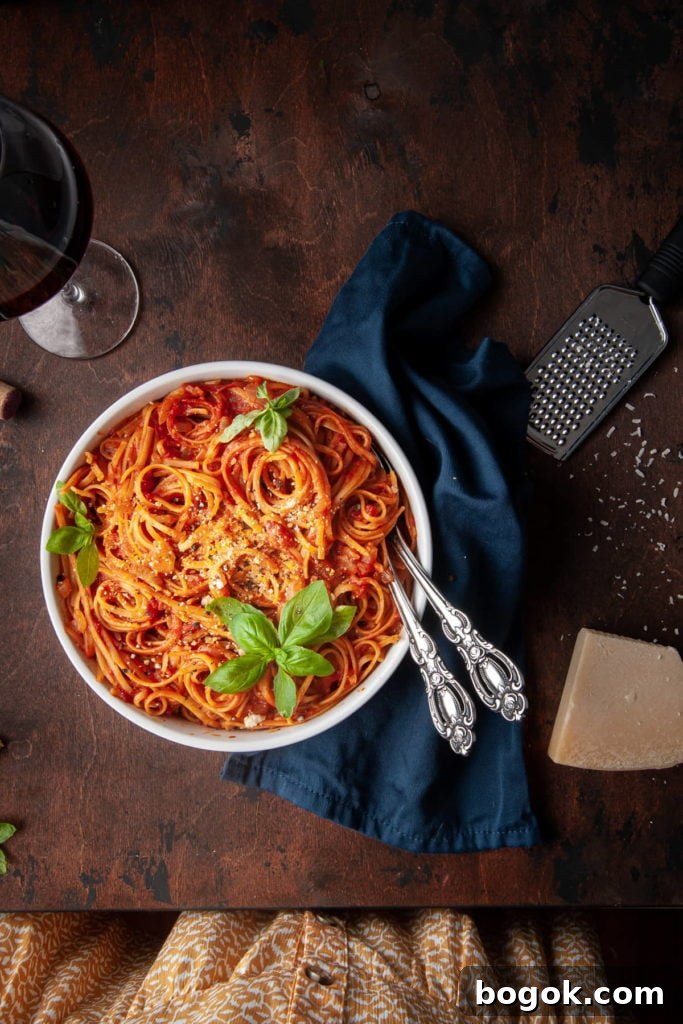 Vegan One-Pot Pasta with Classic Marinara Sauce 6 overhead shot of pasta with tomato sauce and woman's dress whowing