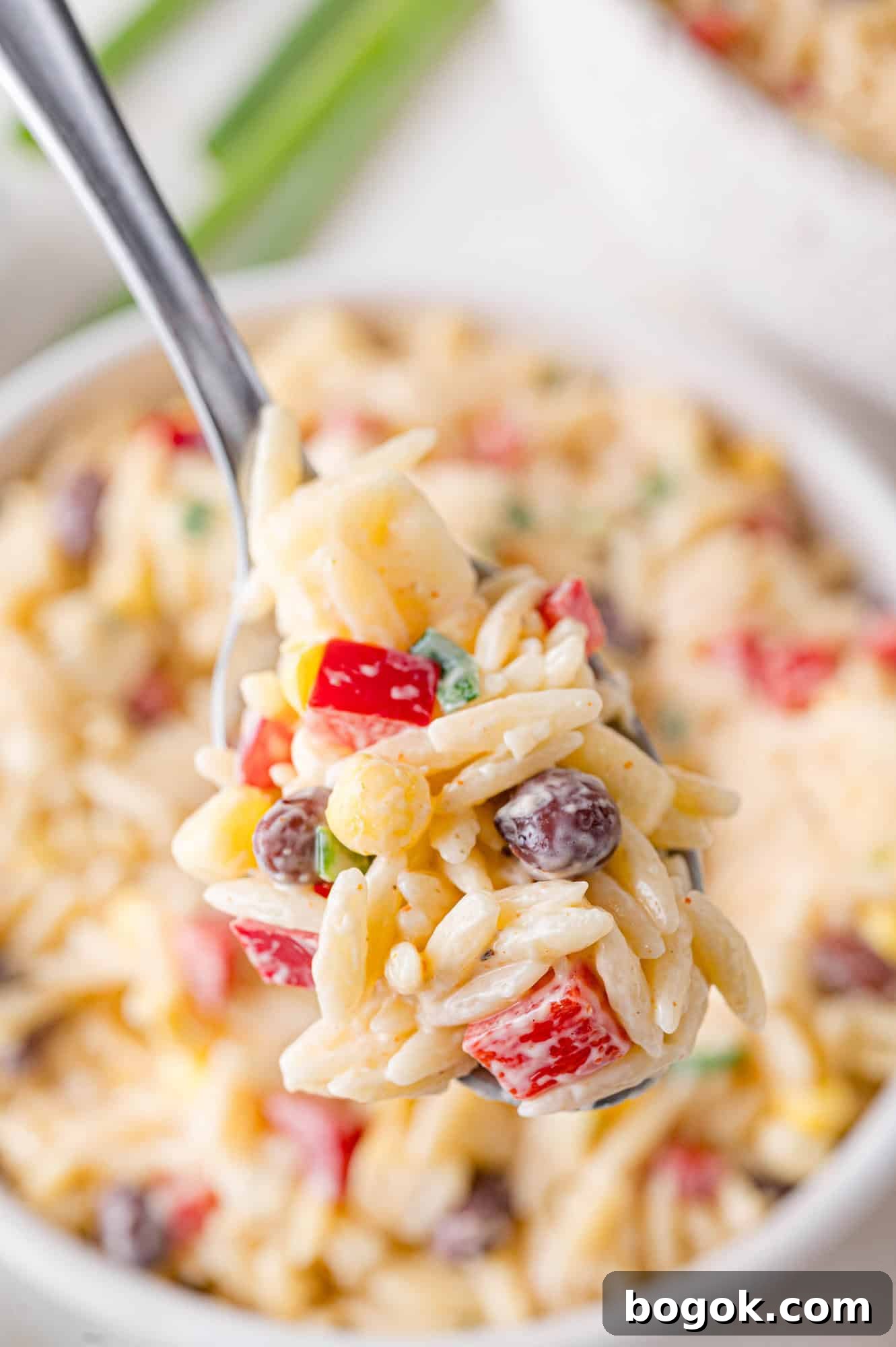 Small scoop of the pasta salad on a spoon.