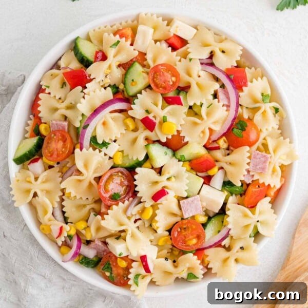 Summer pasta salad in a round white bowl.