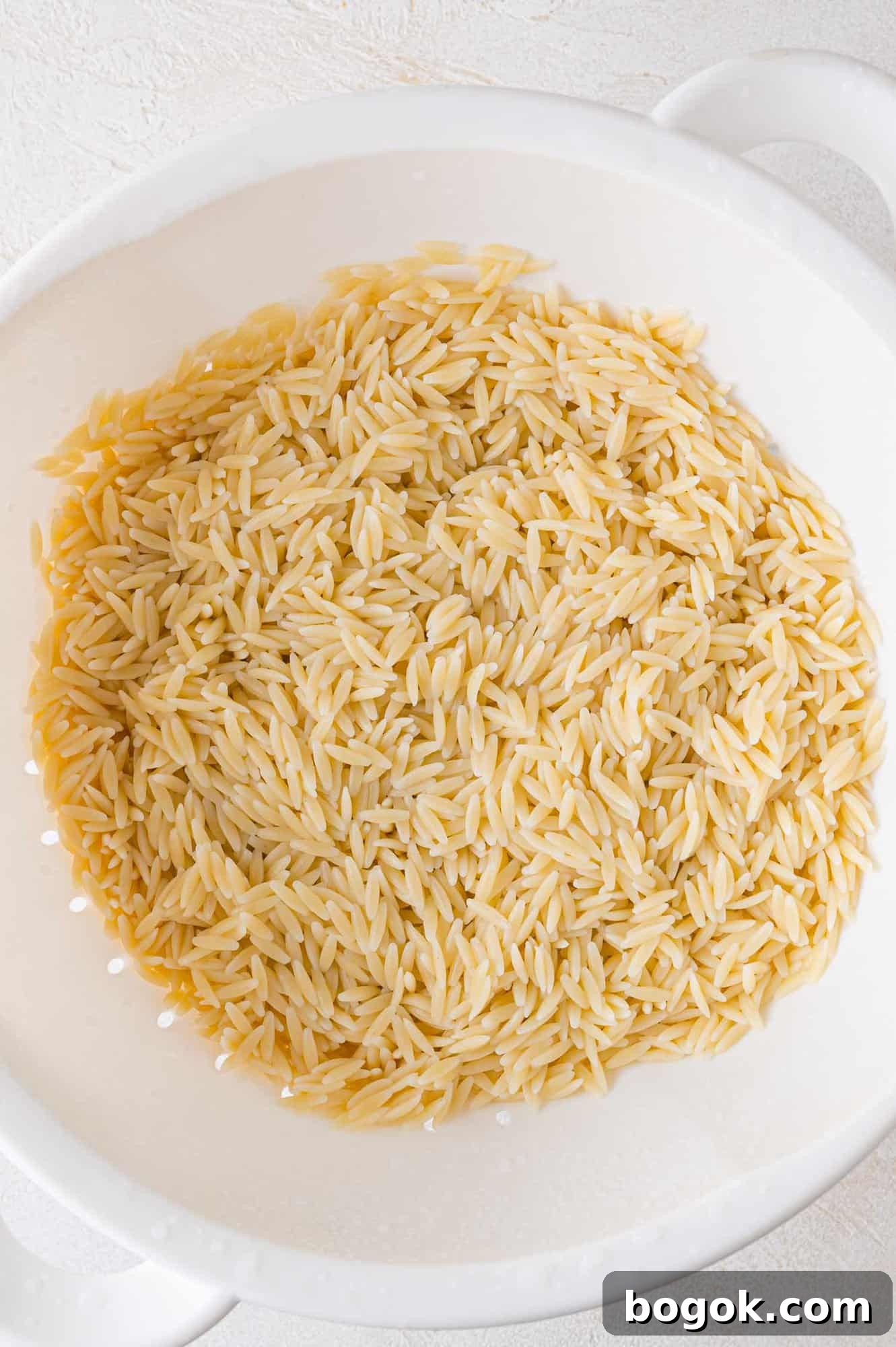 Cooked pasta in a colander.