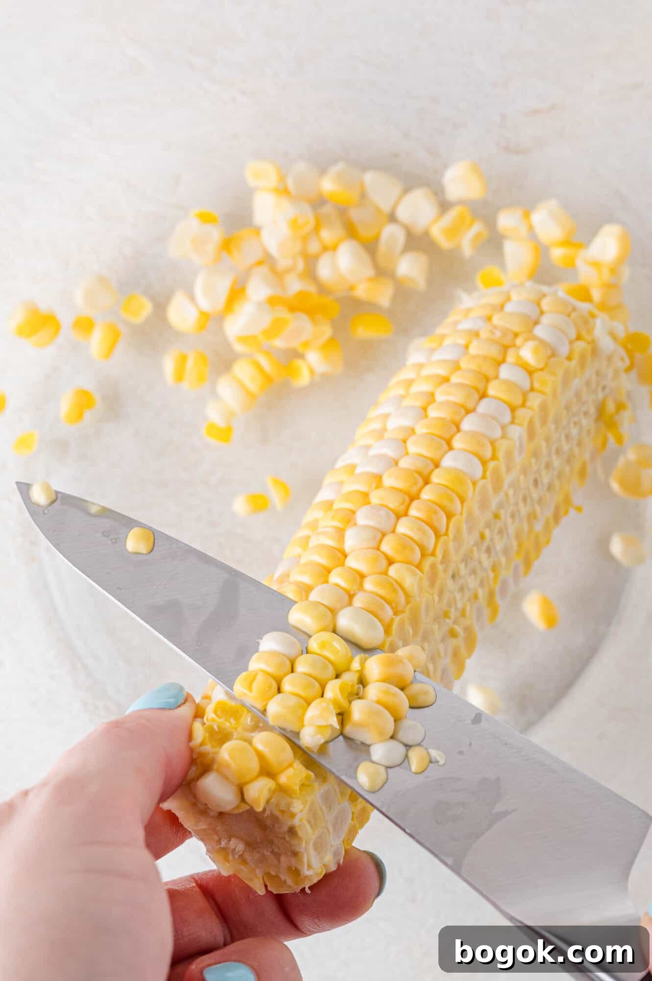 Corn being cut off the cob.