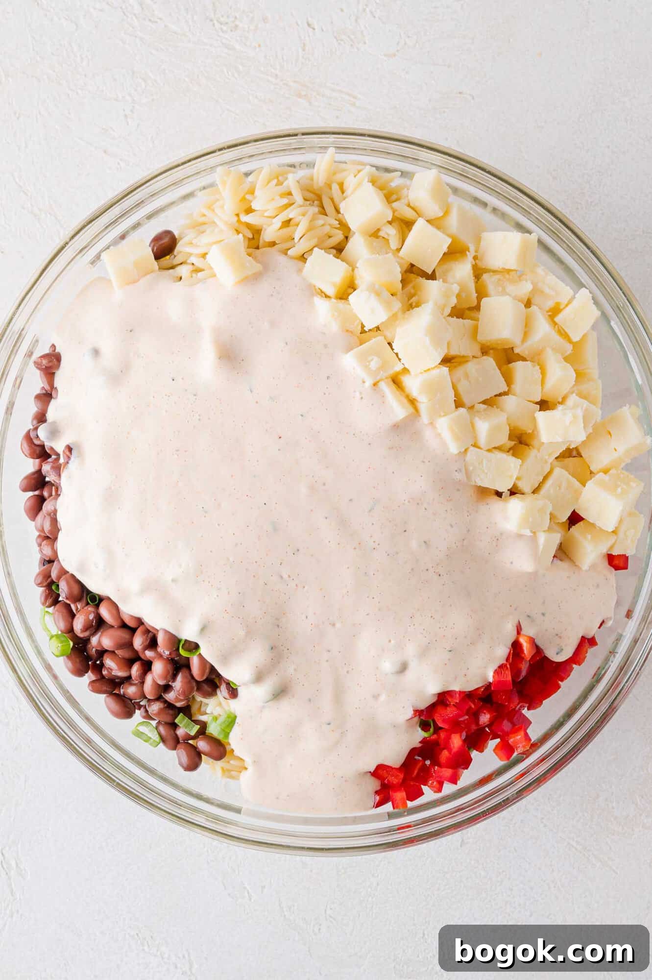 Dressing added to salad ingredients.