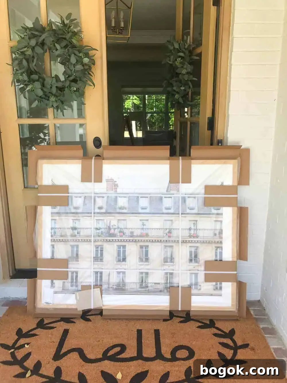 large art in the box on a porch by the front doors