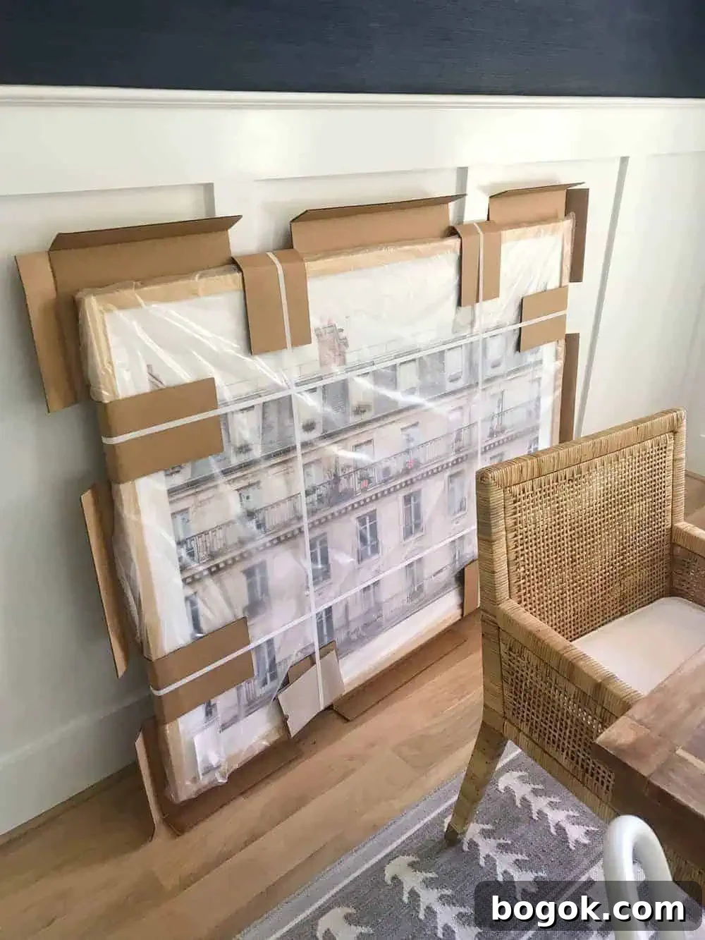 oversized art sitting on the floor in our dining room