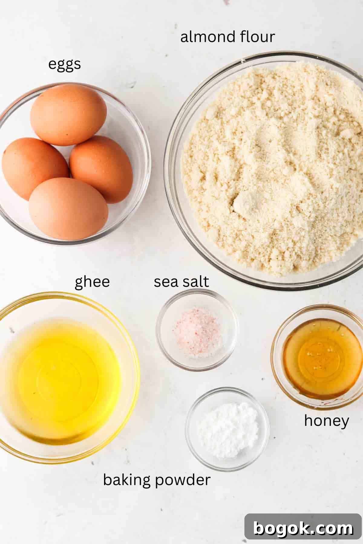 Biscuit ingredients laid out in small glass bowls on the counter.