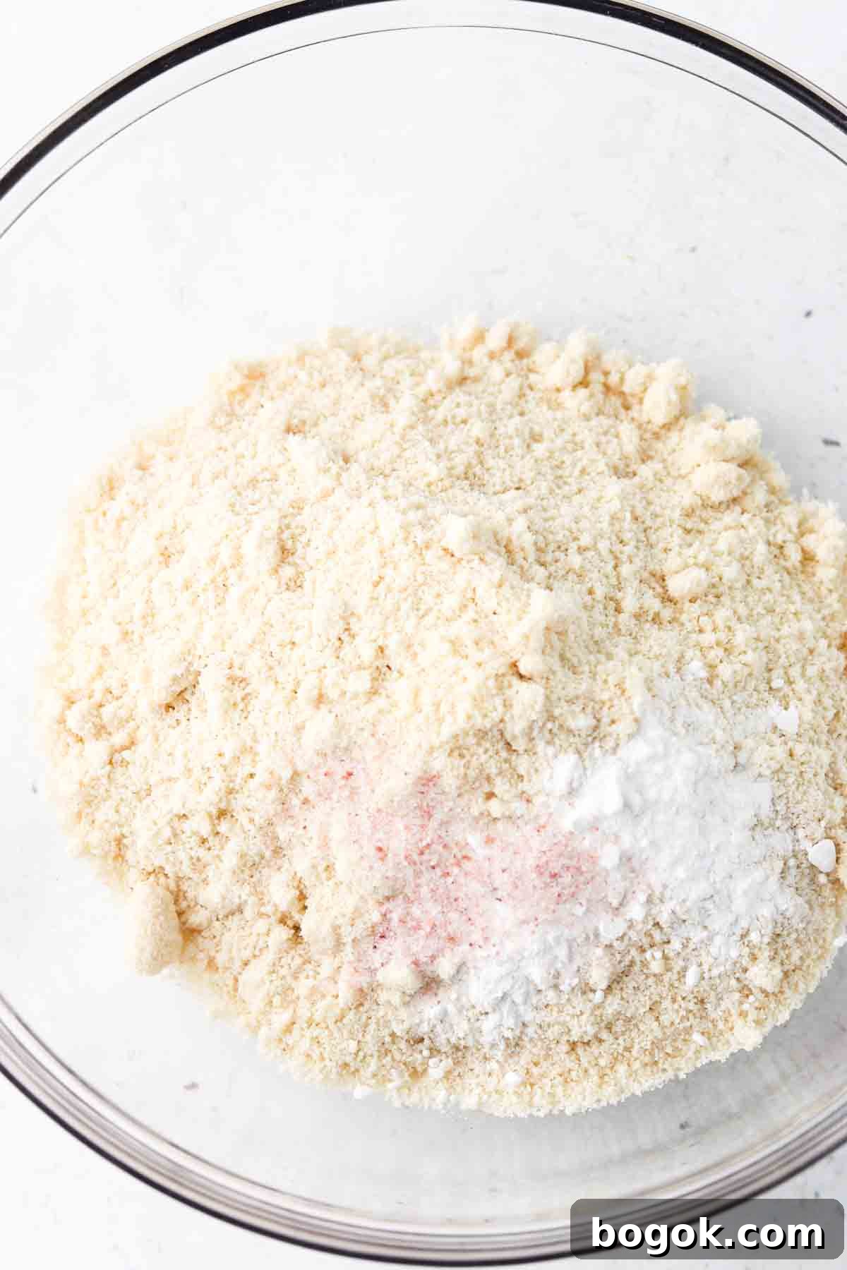 Almond flour, baking soda, and sea salt in a glass bowl.