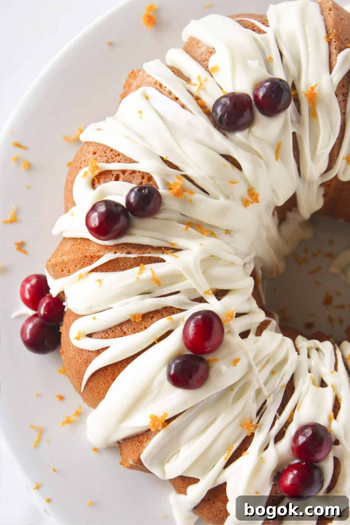 Looking at a delicious Cranberry Orange Bundt Cake with fresh cranberries and orange zest.
