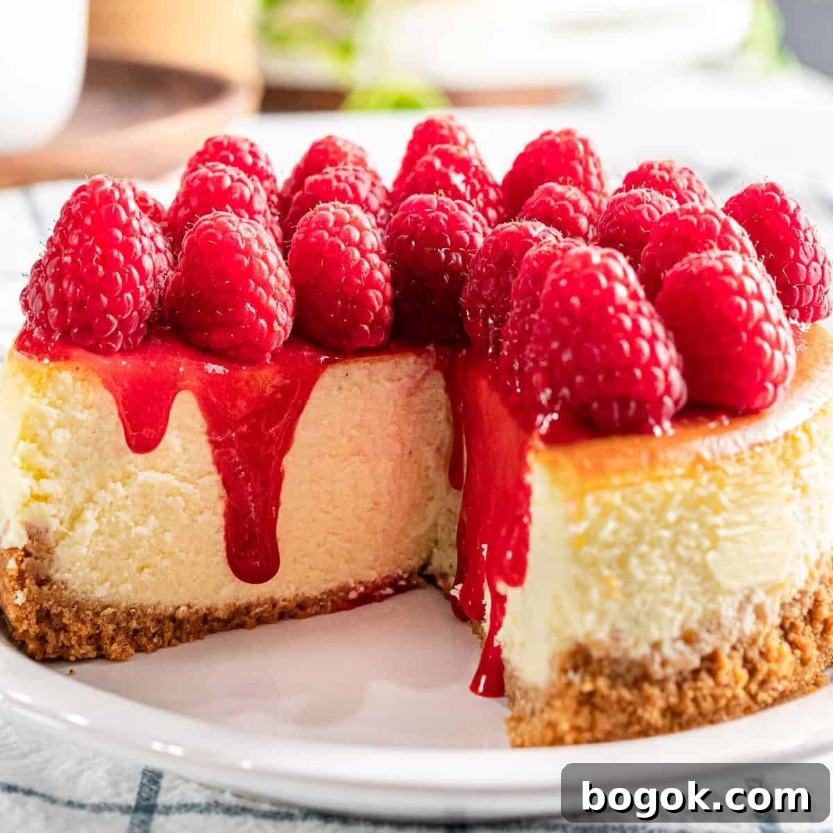 Raspberry cheesecake with fresh raspberry topping and raspberry sauce.