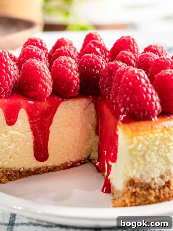Raspberry cheesecake with fresh raspberry topping and raspberry sauce..