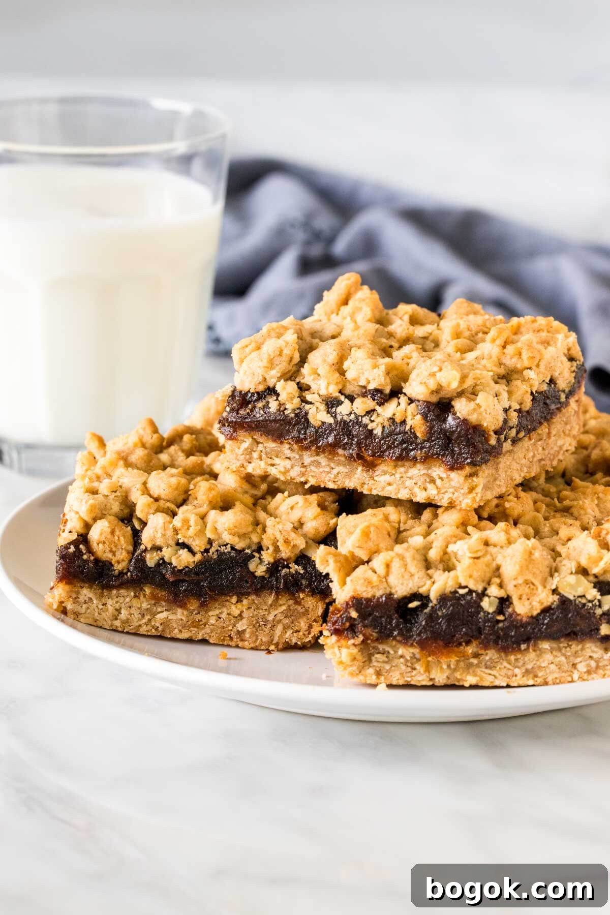 Plate of date squares with a glass of milk.