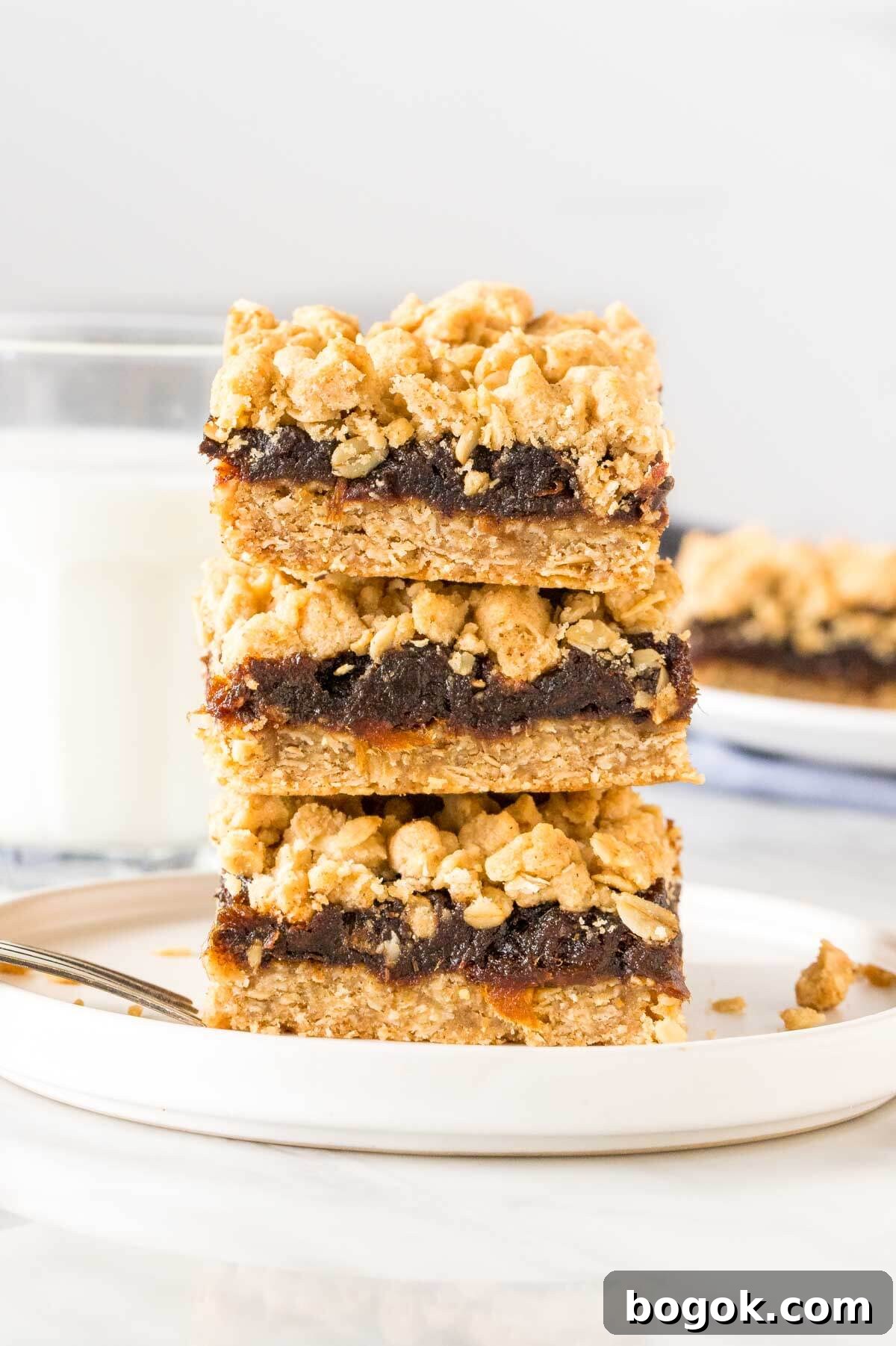 Stack of 3 date squares with oatmeal crumble topping.