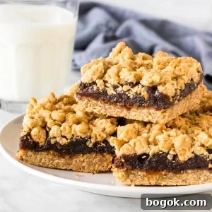 Plate of date squares with a glass of milk.