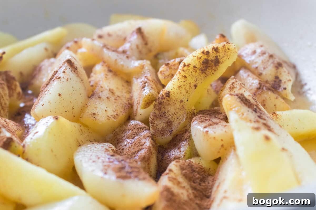 apples and pears with sugar and cinnamon in skillet