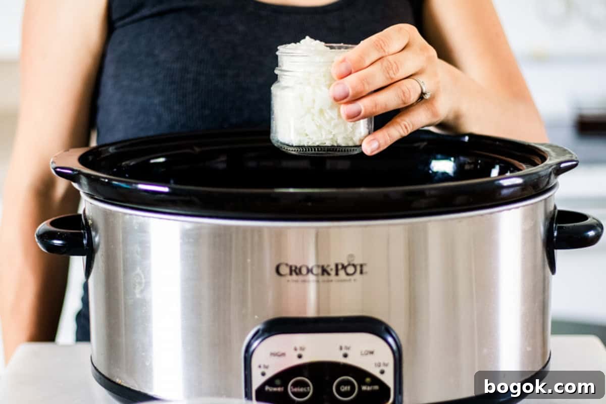 Adding a jar of wax to a crockpot of water.