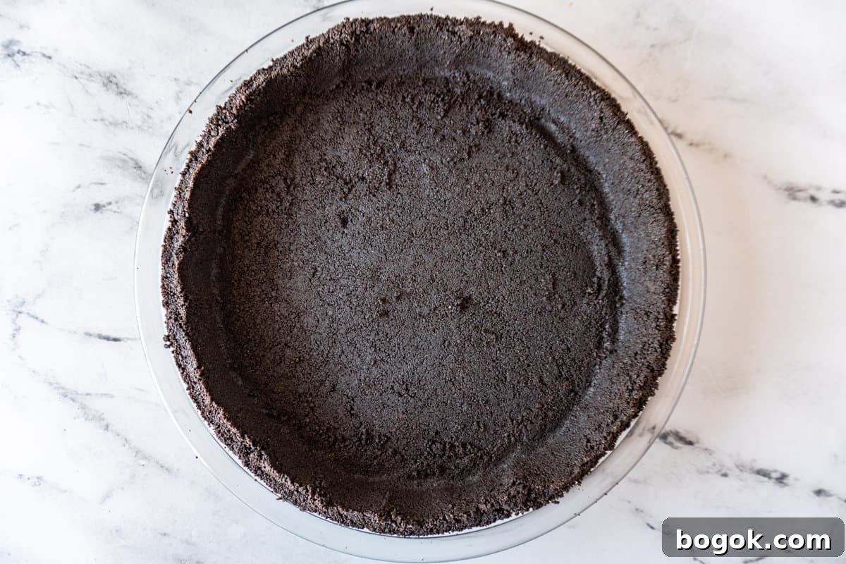 homemade oreo crust in glass pie dish